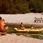 a group of people sitting on a raft in the water